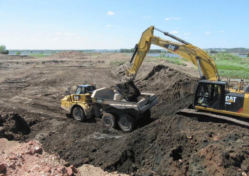 photo of large equipment moving earth at job site